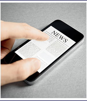 Finger touches a smartphone with a news page open